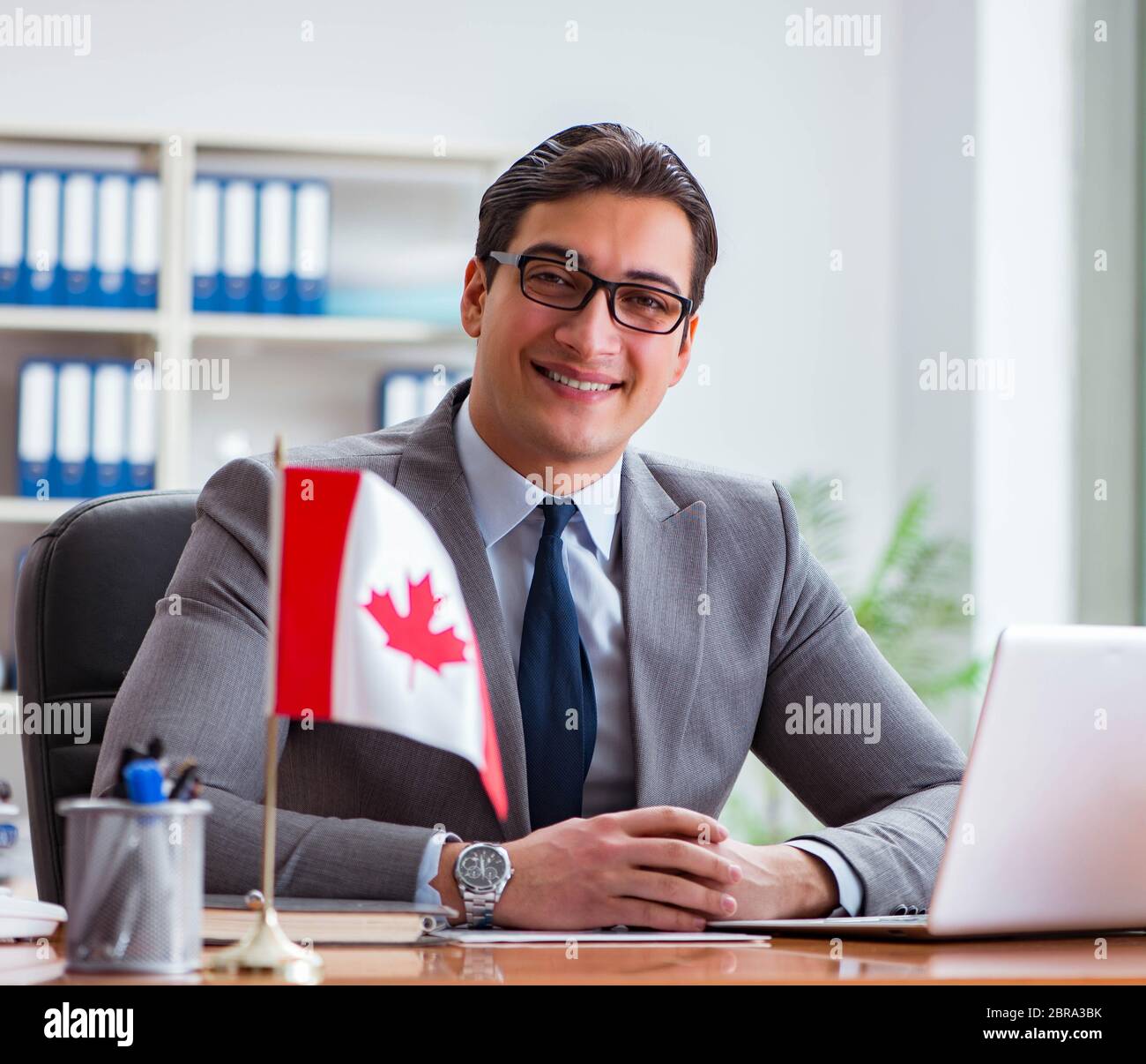 The businessman with canadian flag in office Stock Photo - Alamy