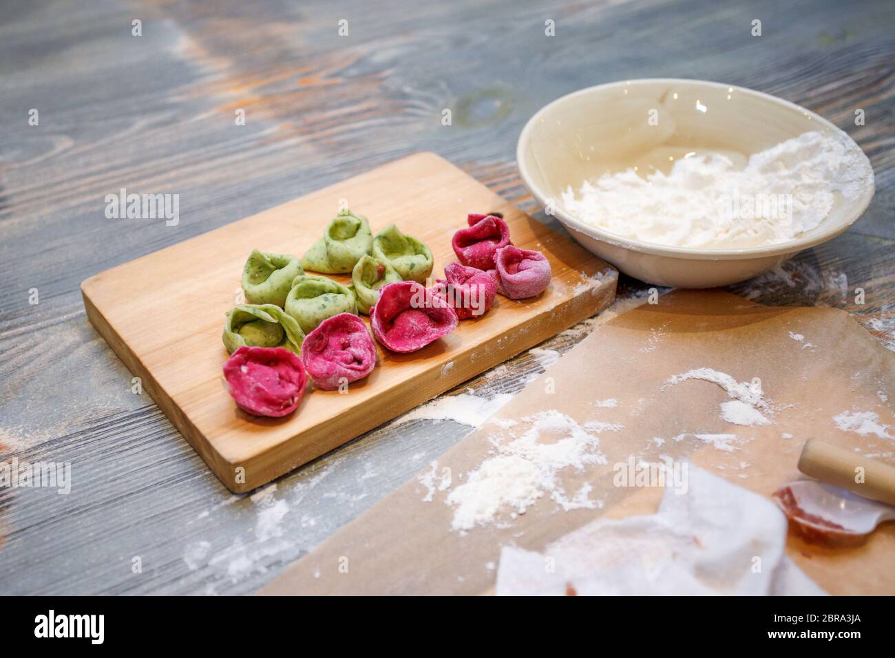 Cooking class, culinary. food and people concept, molding of colorful pelmeni or meat dumplings, national traditional food, creative color menu Stock Photo