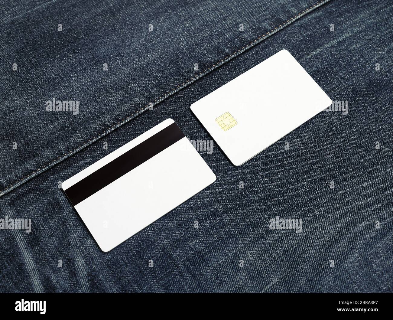 Two blank credit cards on denim background. Front and back view. Copy space for text. Stock Photo