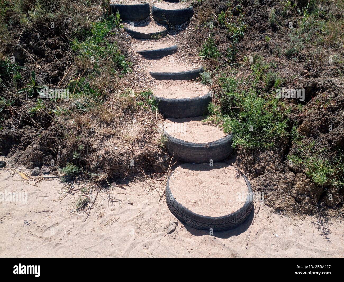 Steps to the top of the hill, made of car treads. Creative from old car