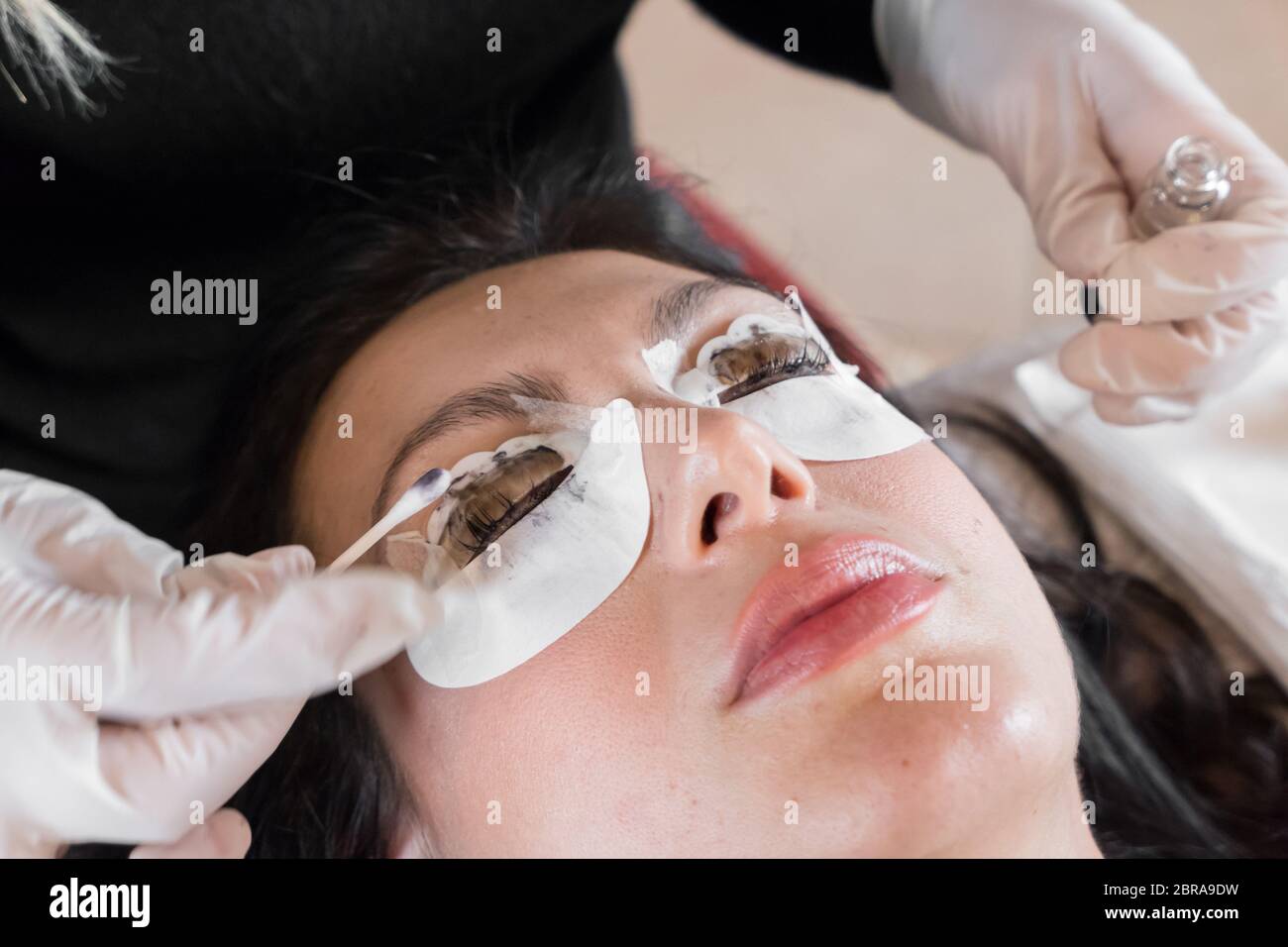 Cosmetic procedure of dyeing and lamination of eyelashes. Extension, perm, lamination of eyelashes. Eyelash care. Stock Photo