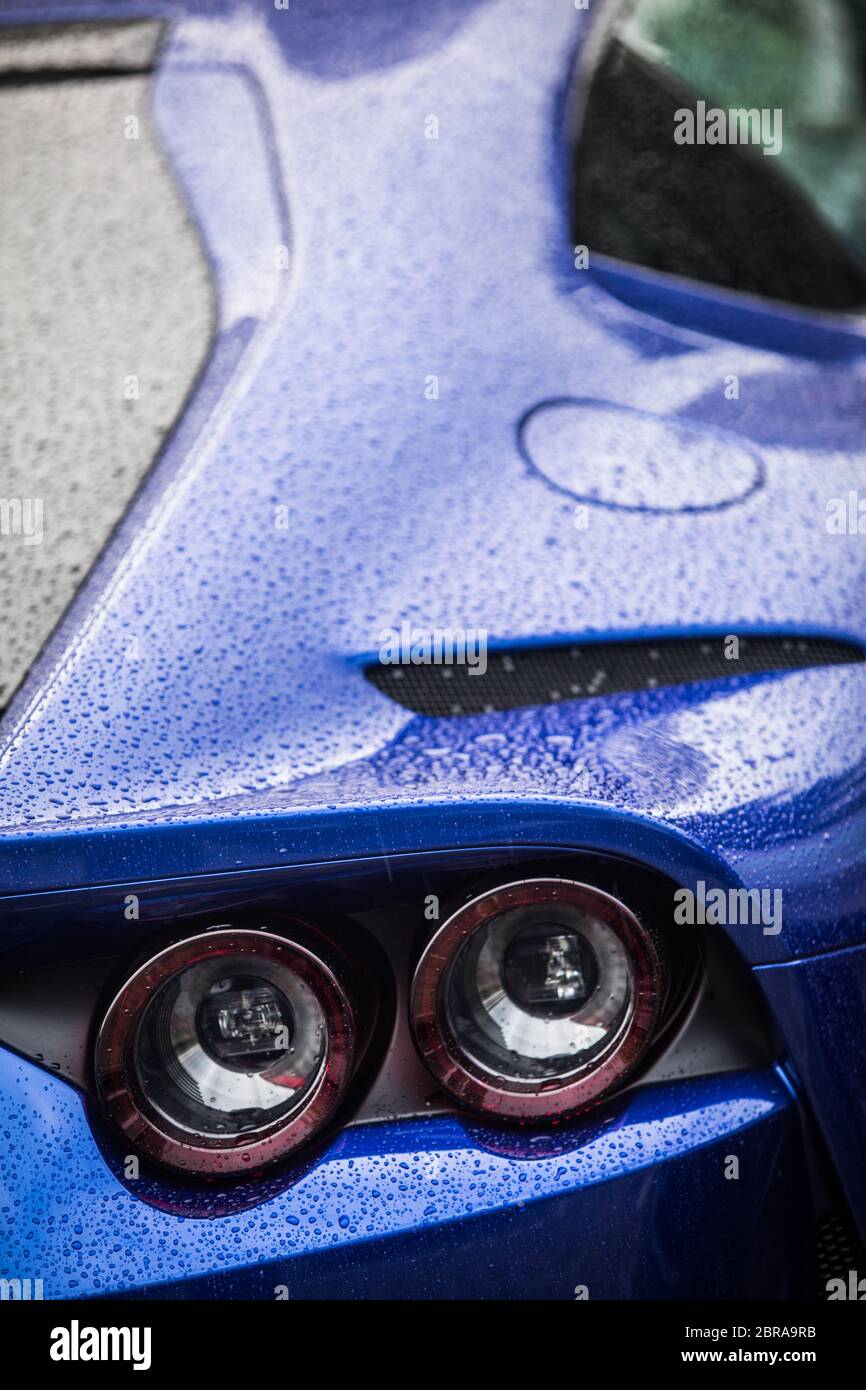 Close up horizontal image of the round tail lights of a new sport super car Stock Photo Alamy