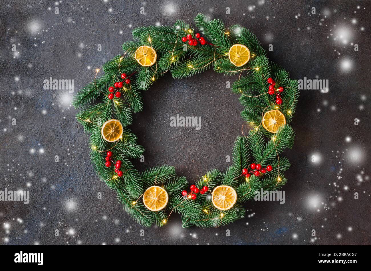 Christmas door wreath made of tree fir branches with xmas lights and ...