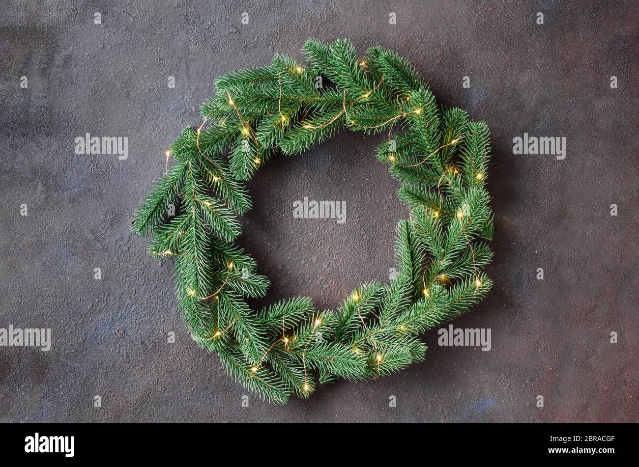 Christmas door wreath made of tree fir branches with xmas lights on ...
