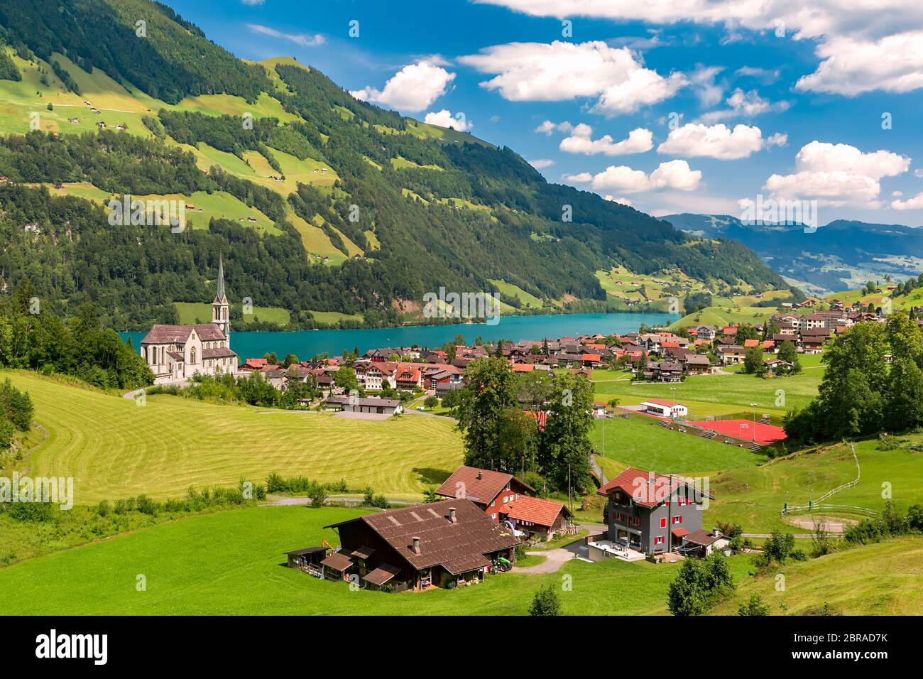 Swiss village Lungern with its traditional houses and NeoGothic church