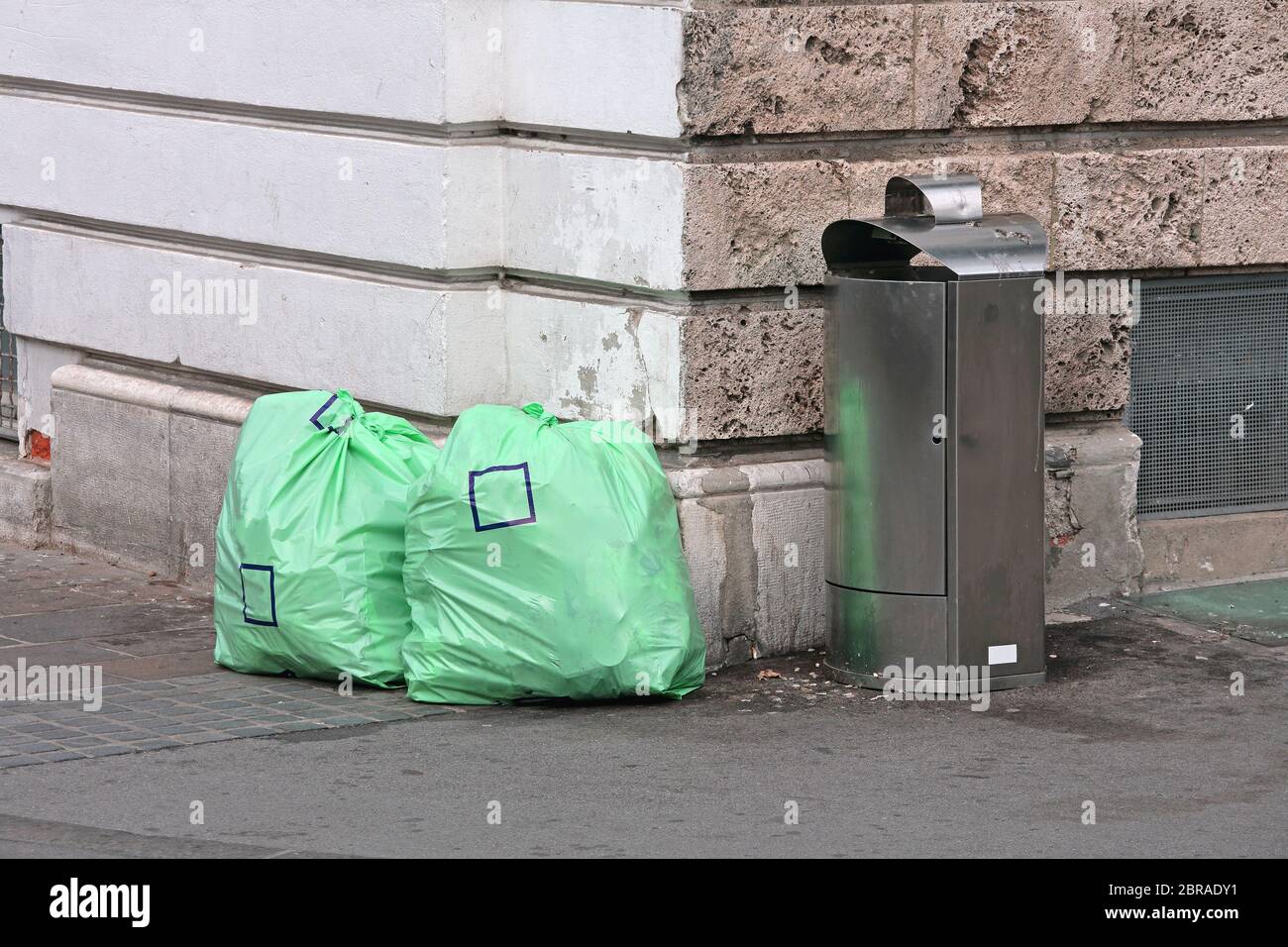 Two Garbage Bags and Trash Bin at Street Corner Stock Photo Alamy
