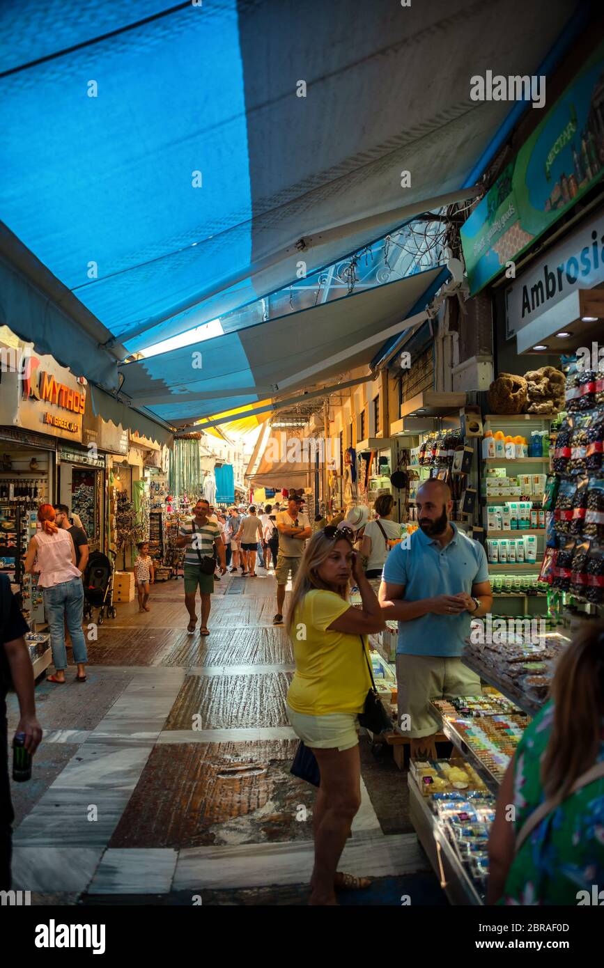 Tourists and local Greeks shop at the outdoor shopping center and