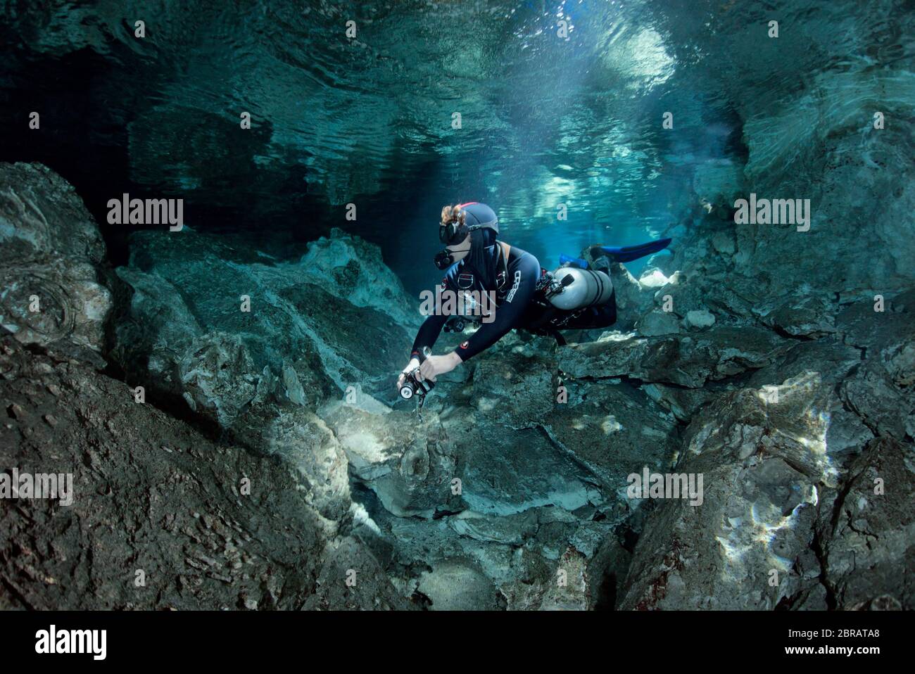 Sidemount technical diver swimming in the Tajma Ha (Taj Mahal) cenote in Playa del Carmen. Stock Photo