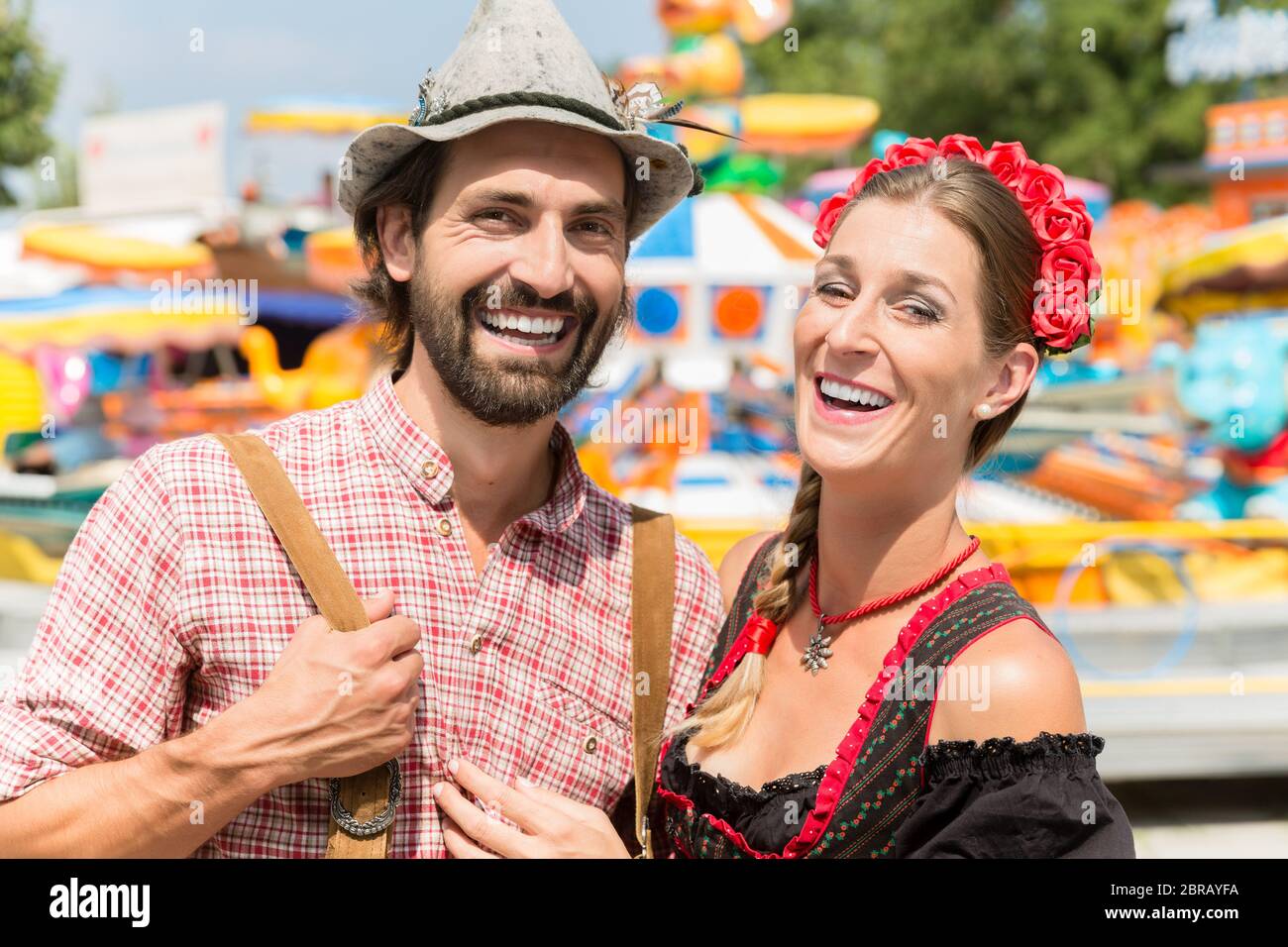 Couple having fun on Bavarian fair or Oktoberfest, man and woman Stock Photo