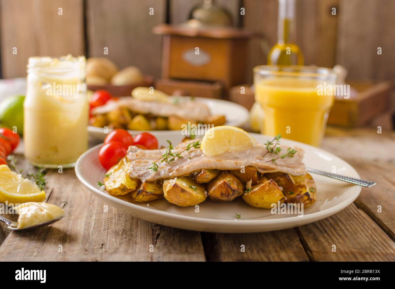 Baked rainbow trout with roasted potatoes and homemade mayonnaise Stock