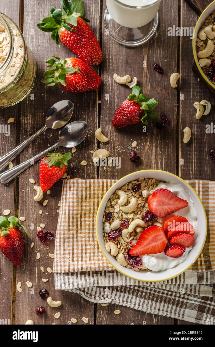 oatmeal with yogurt, fresh strawberries and nuts, healthy breakfast