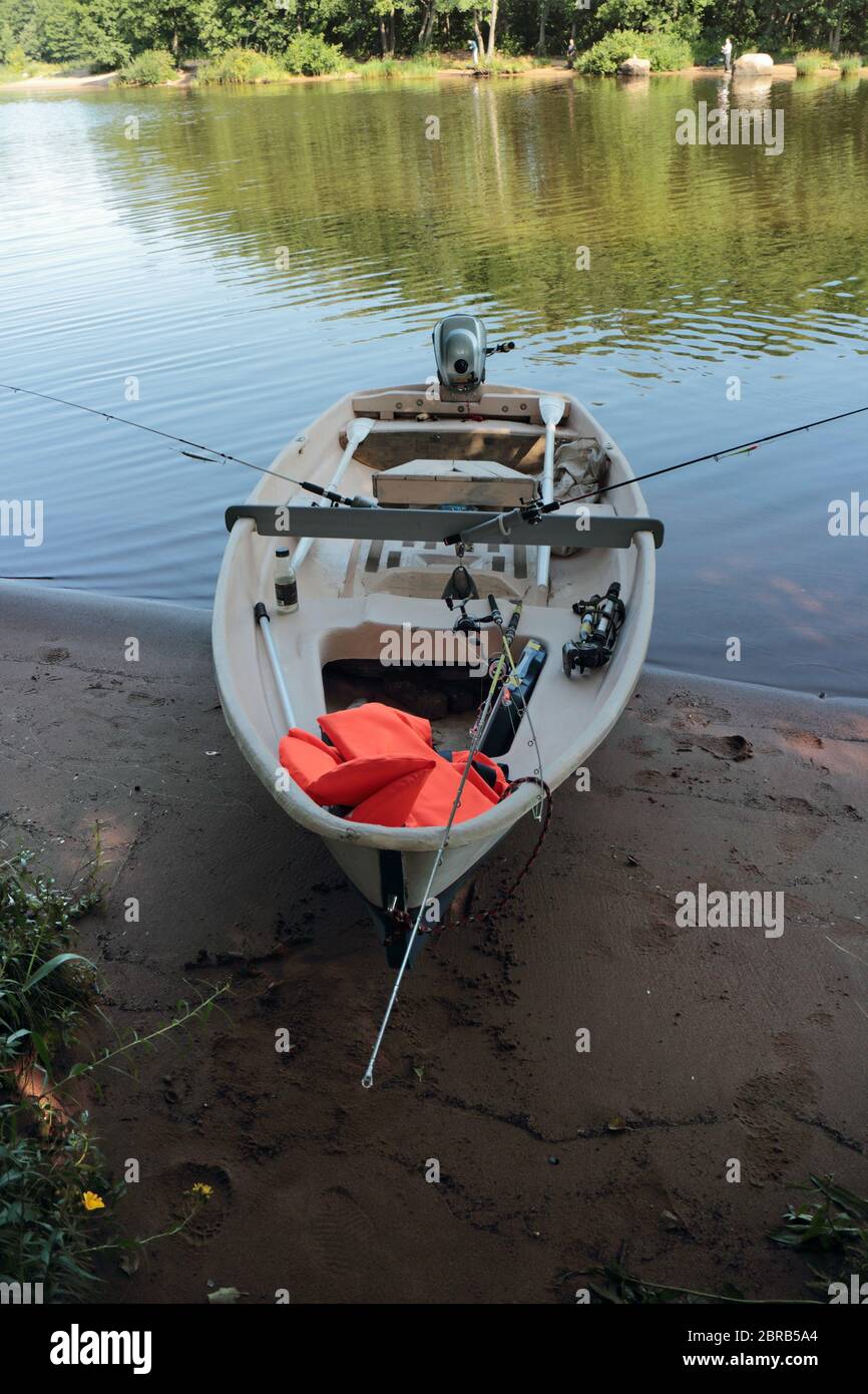 fishing boat with fishing rods mooring on the shore Stock Photo Alamy