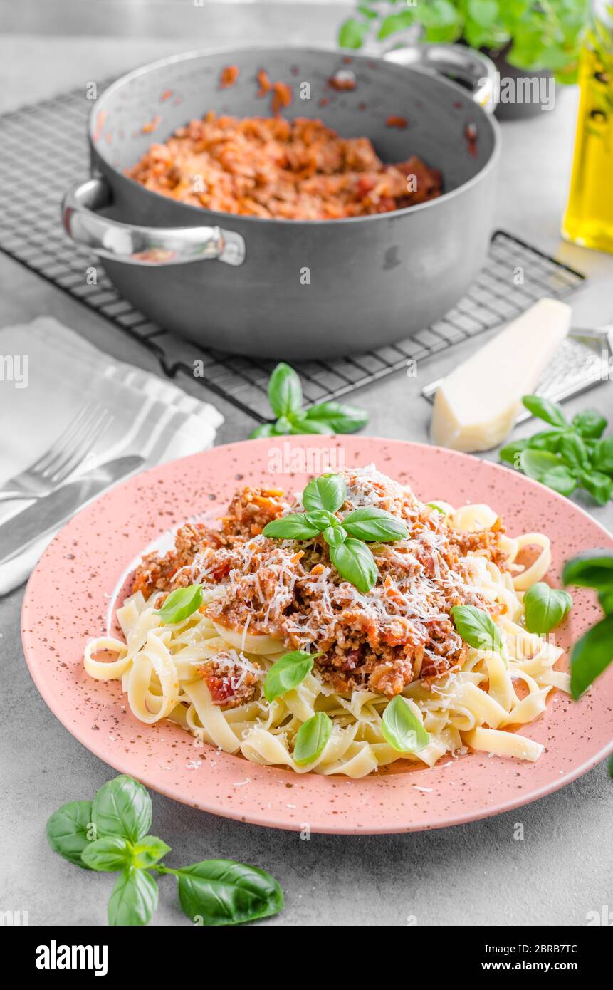 Pasta bolognese delish food, topped with fresh basil herb Stock Photo
