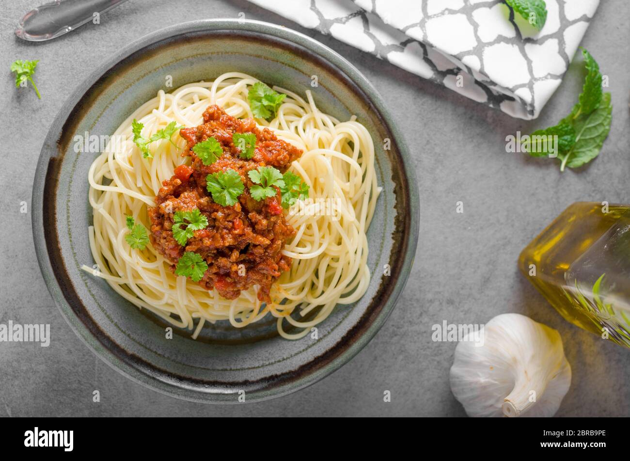 Spaghetti bolognese homemade, rustic styled photo with herbs Stock