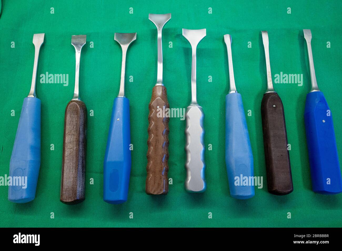 different surgical chisels lie side by side on a surgical drape Stock