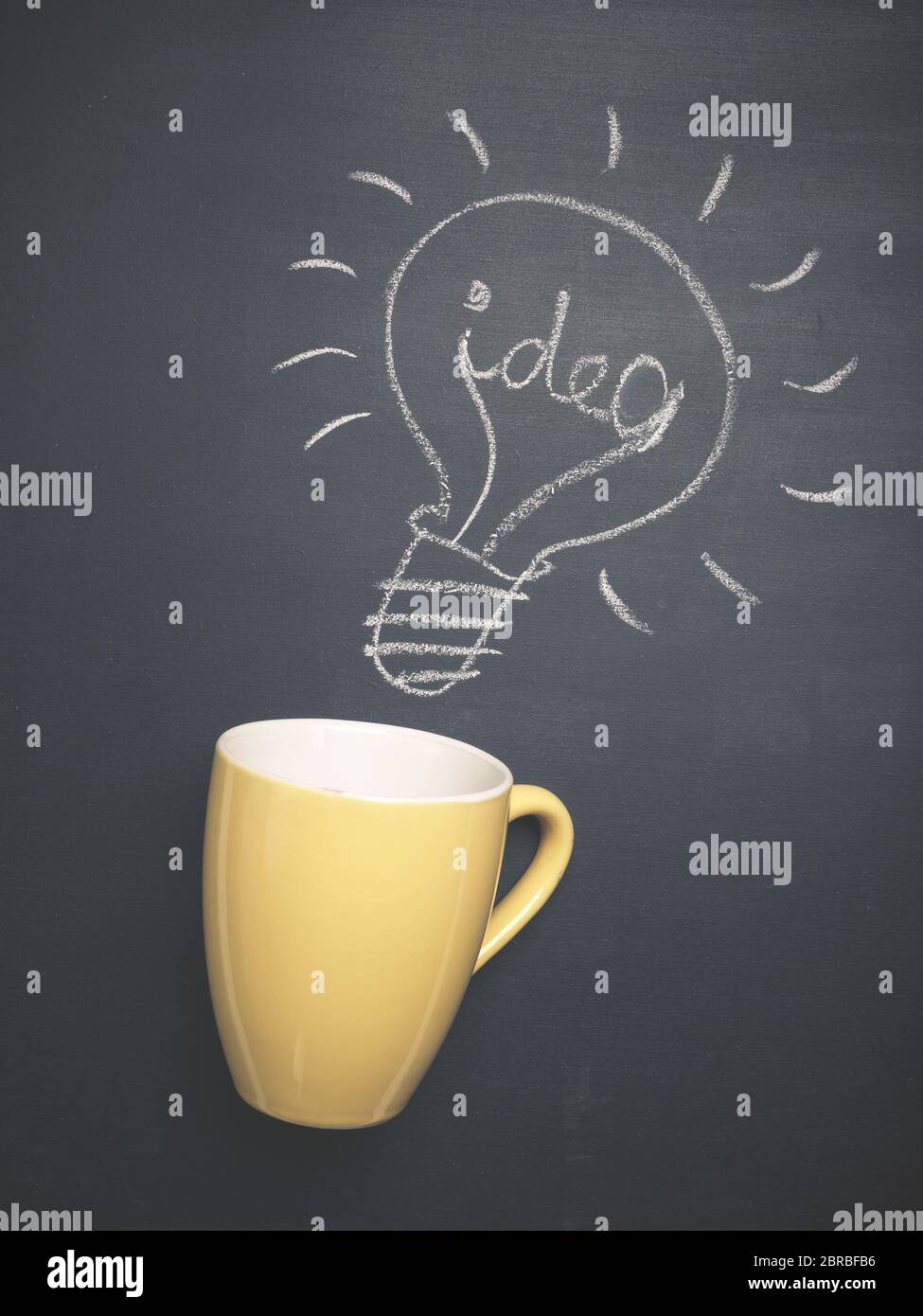 Coffee cup with a light bulb and the word idea on a chalkboard, great idea concept Stock Photo