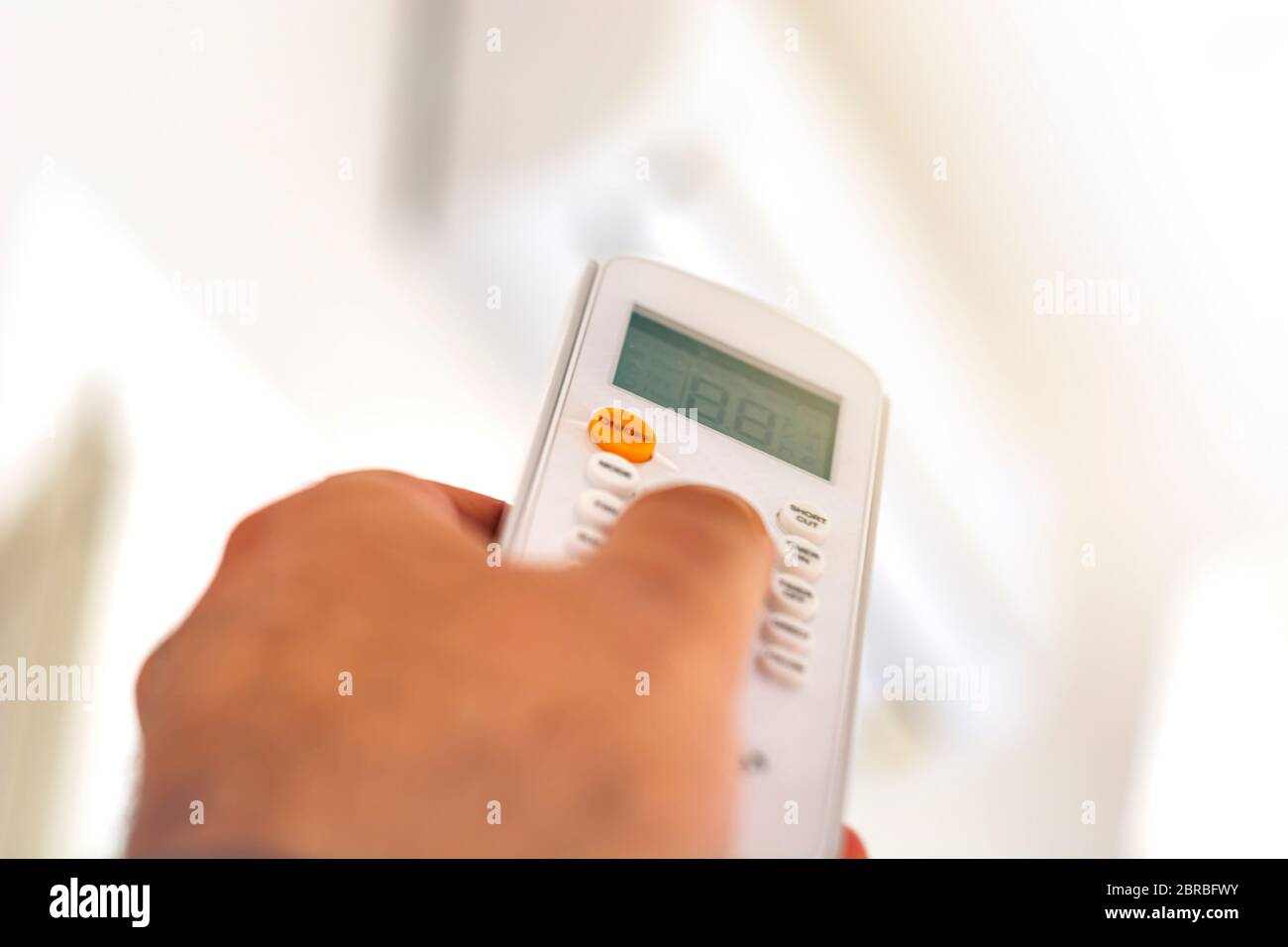 closeup view of a hand adjusting the air conditioning temperature