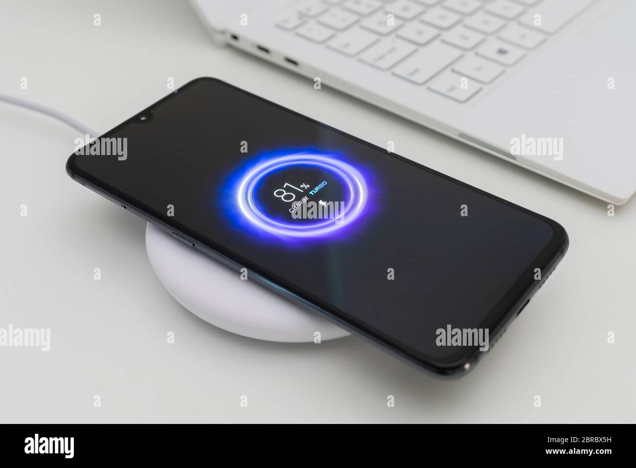 Charging smartphone using wireless charger Stock Photo