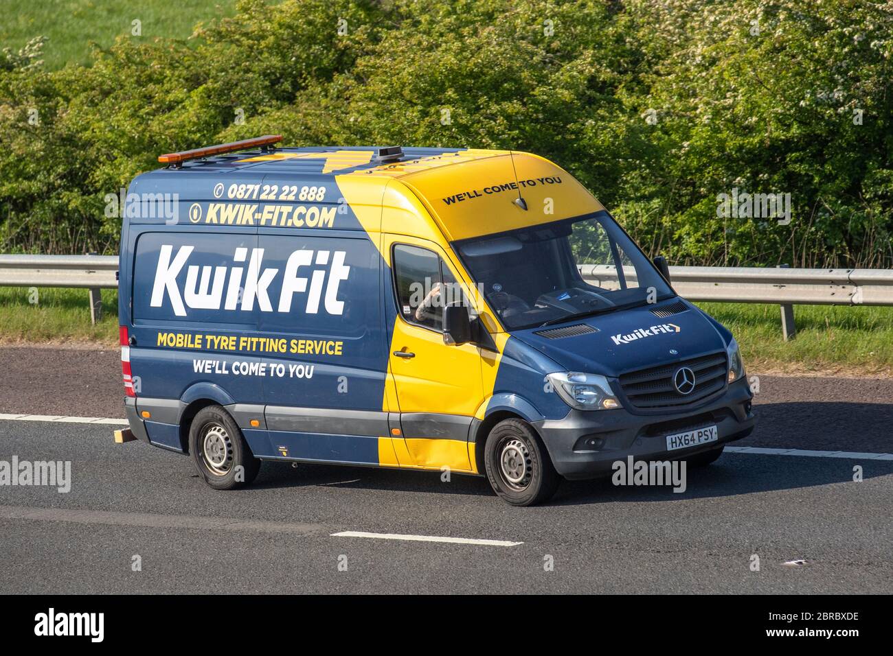 KwikFit Mobile tyre fitting service; Delivery trucks,blue yellow lorry,  transportation, truck, cargo carrier, service vehicle, European commercial  transport, industry, driving on the M6 at Manchester, UK Stock Photo - Alamy