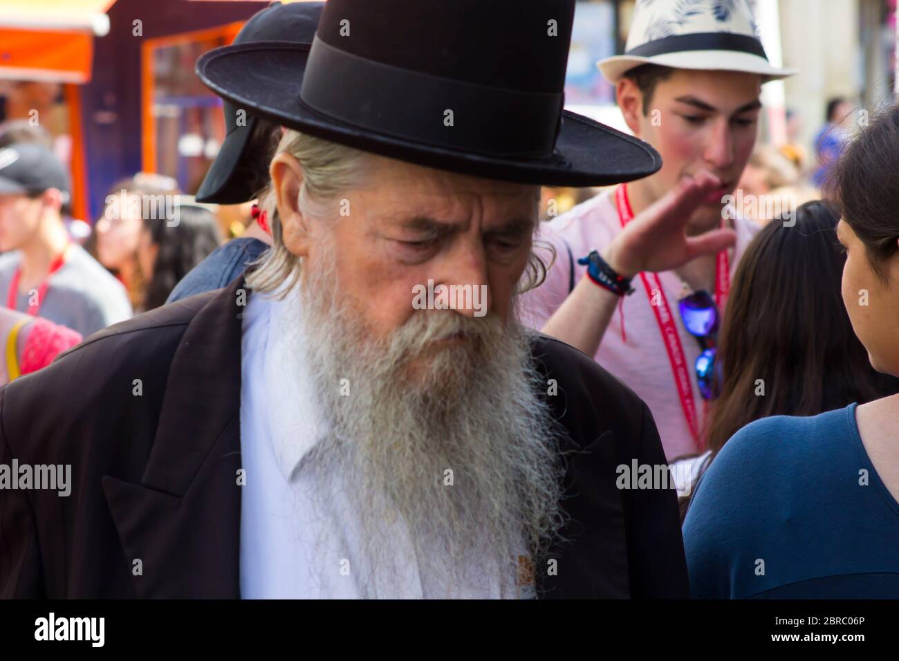 9 May 2018 An aged Hasidic Jew with a long white beard in traditional clothing on foot in a busy street in Jerusalem Israel Stock Photo