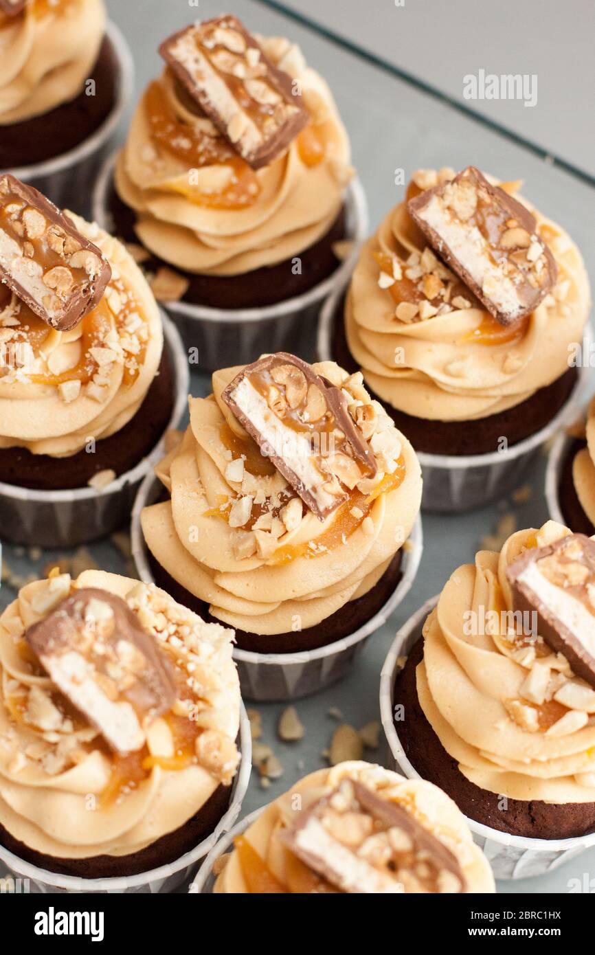 Cupcakes with peanut butter cream cheese frosting, chocolate bites