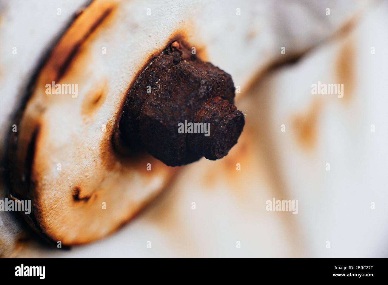 Scrap metal. Rust under a coat of paint. Peeled off white paint