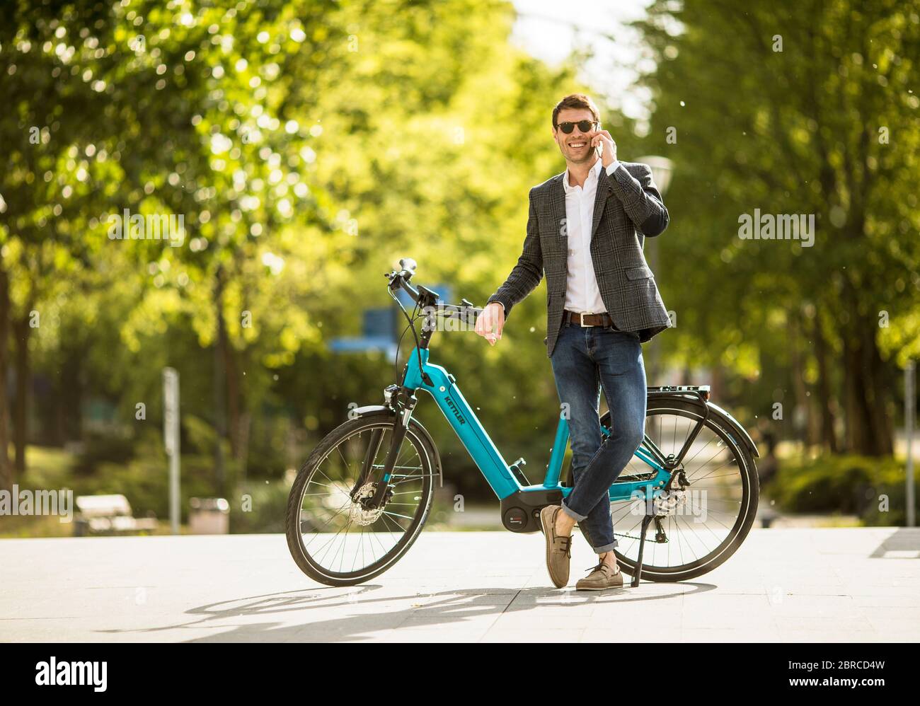 Young businessman on the Kettler Quadriga CX10 ebike with mobile phone  Stock Photo - Alamy