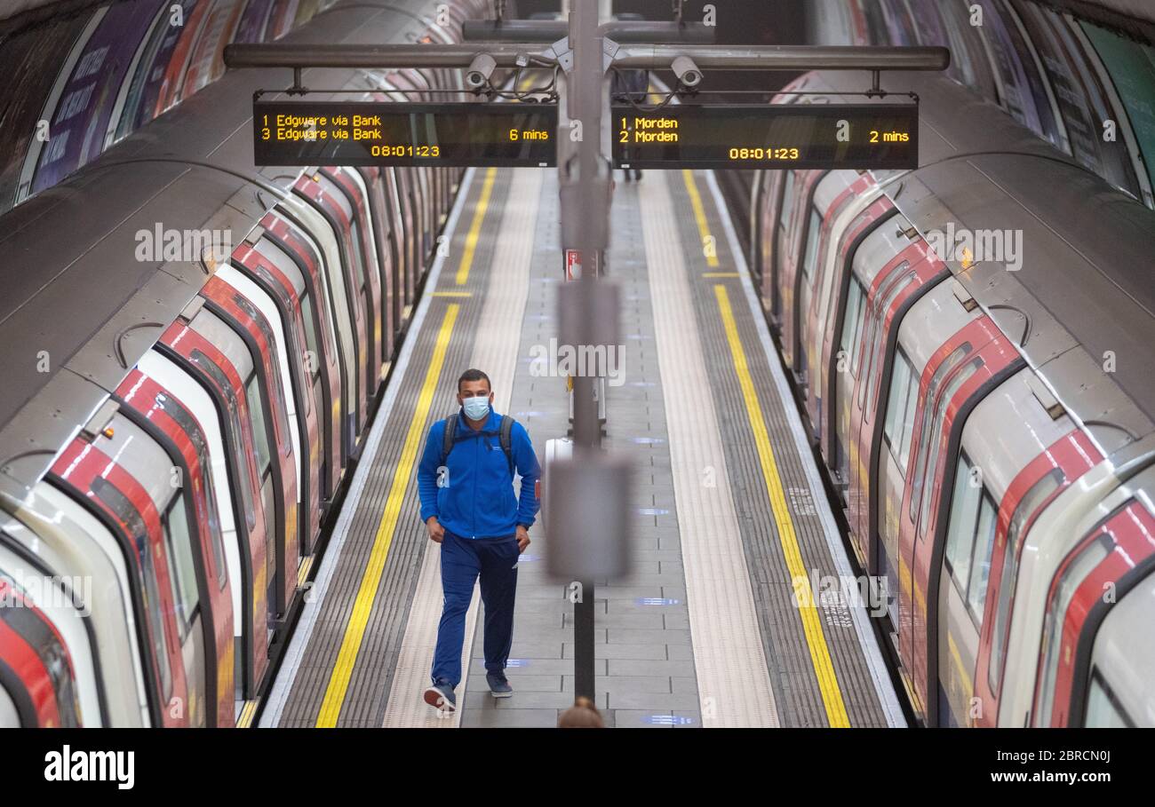 Commuter wearing protective face mask at clapham common underground