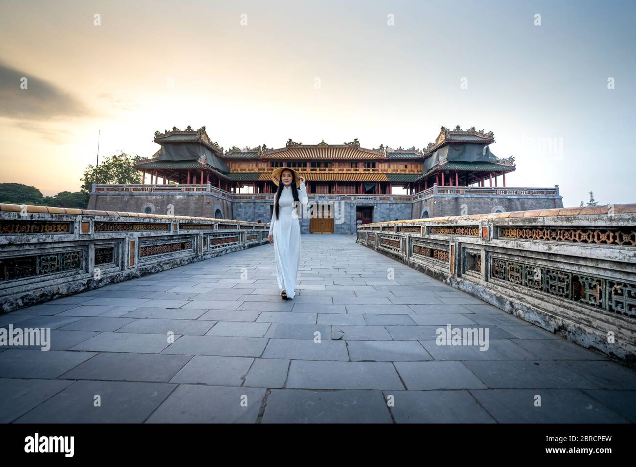 Hue City, Thua Thien Hue Province, Vietnam - May 7, 2020: Photo of a girl in a traditional ao dai costume inside a temple in Hue City, Thua Thien Hue Stock Photo