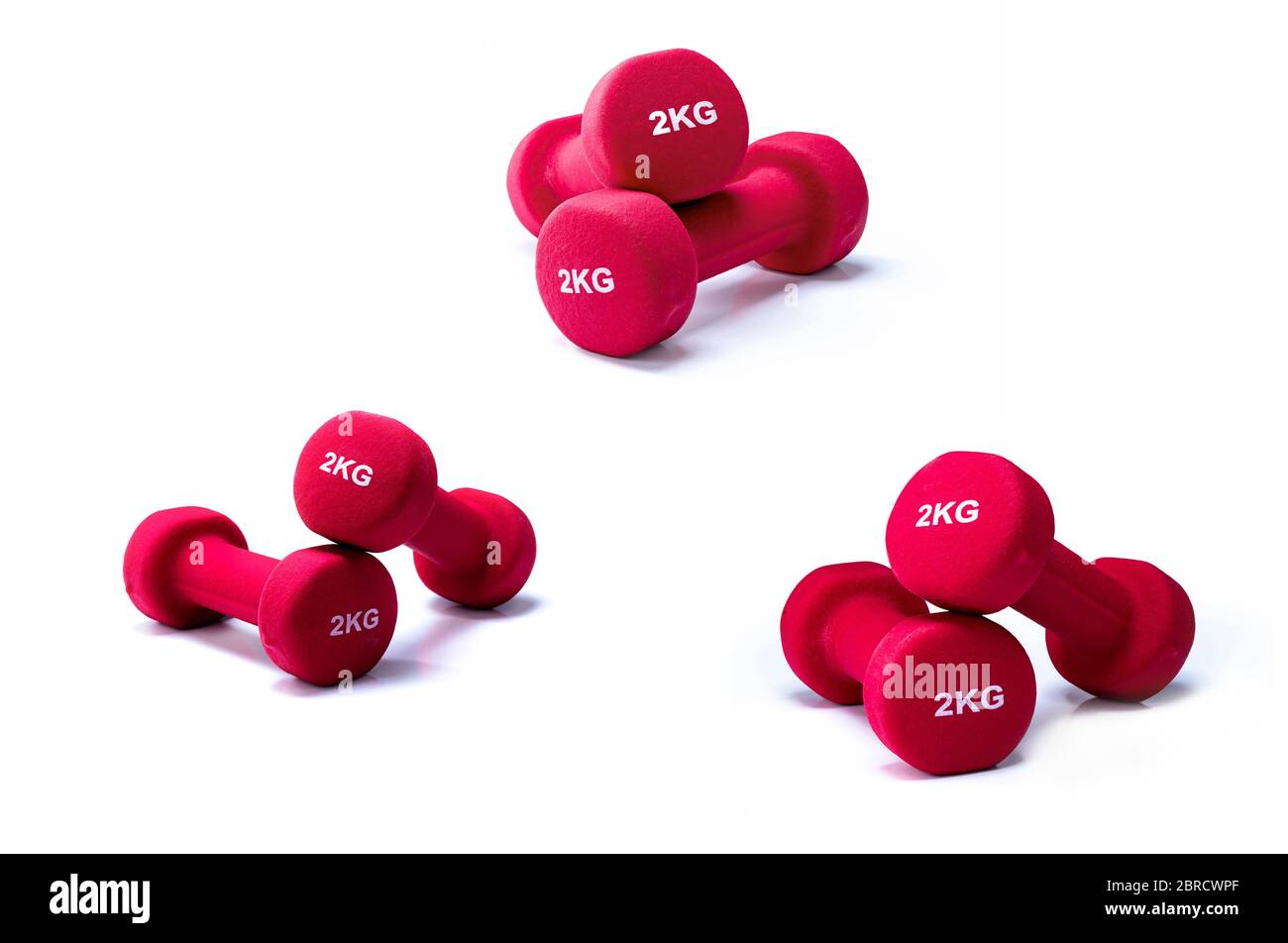 Set of red dumbbells isolated on white background. 3 pairs of red neoprene dumbbells. Home gym equipment for exercise at home. Weight training Stock Photo