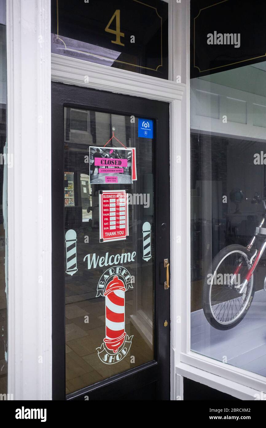 Closed Until Further Notice Sign On A Barbers Shop In Douglas Isle Of