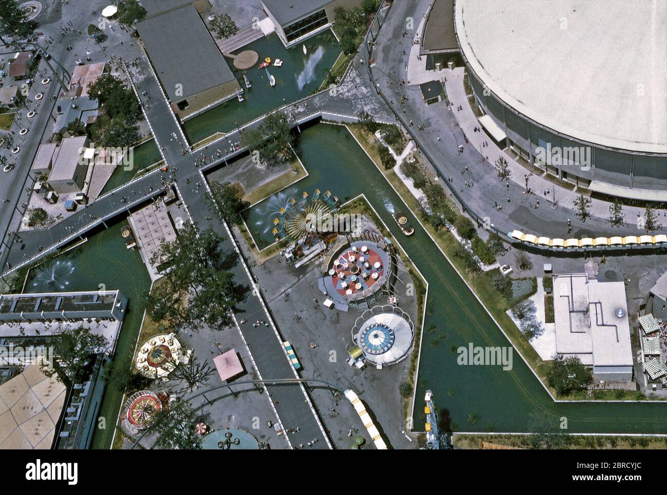 An overhead view of 'HemisFair '68', an official World's Fair (Expo or International Exposition) held in San Antonio, Texas, USA in 1968. The photograph was taken from The Tower of the Americas. The waterway system with boats on snakes through the site as do two 'Mini-Monorail' trains. The HemisFair Arena is top right. Stock Photo