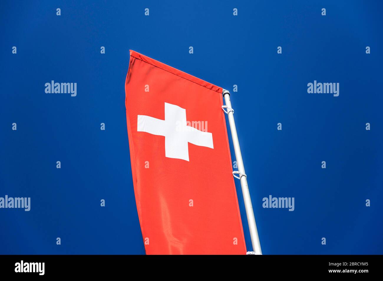 Swiss national flag in front of blue sky, Canton of Zurich, Switzerland