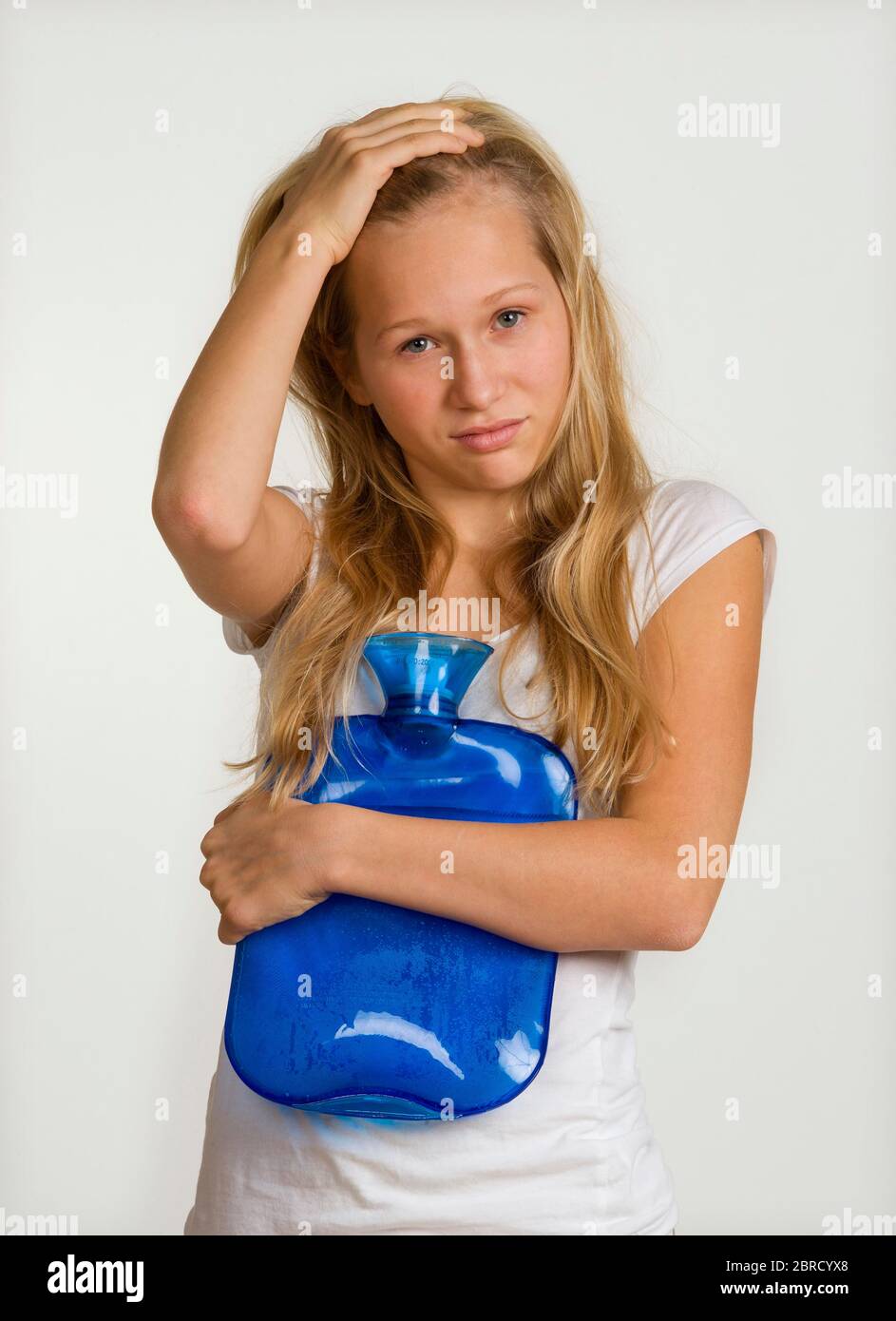 Sick girl with hot water bottle, Germany Stock Photo Alamy