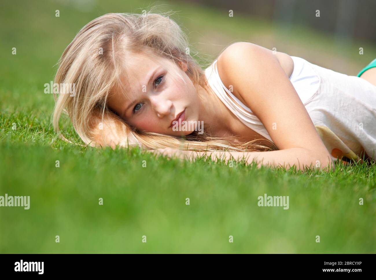 Blonde girl lying relaxed in a meadow, Austria Stock Photo