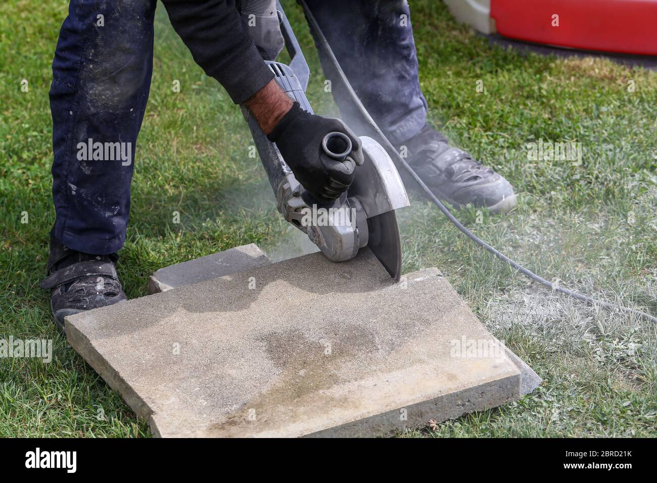 Industrial construction worker using a professional angle grinder Stock Photo