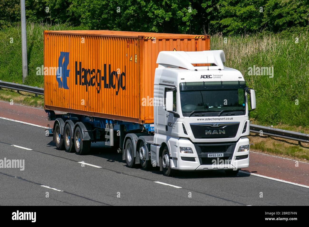 ADBC Transport Ltd; Haulage Hapag-Lloyd shipping container delivery trucks, lorry, transportation, truck, cargo carrier, Man vehicle, European commercial transport, industry, M6 at Manchester, UK Stock Photo