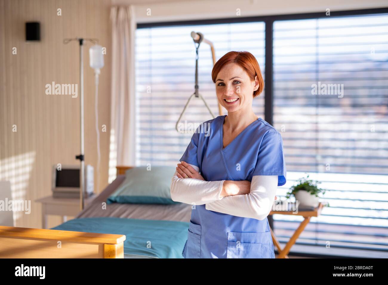 Portrait of female doctor or nurse standing in hospital room Stock ...