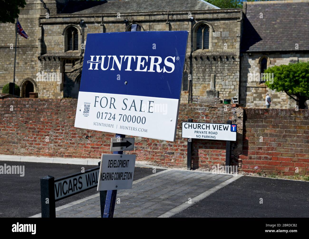 House for sale sign in front of church, Crowle, Lincolnshire, England