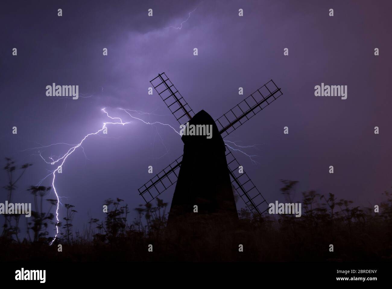 Fork lightning strikes during night summer storm behind Beacon Mill, an