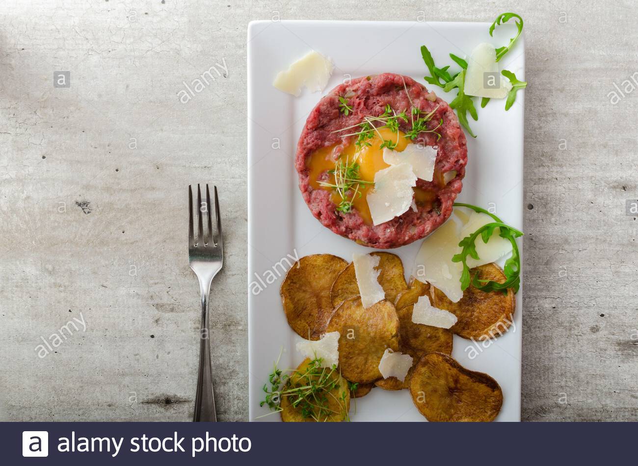 Beef Tartar Homemade Potato Chips Sprinkled With Parmesan Shavings And Microgreens Stock Photo Alamy