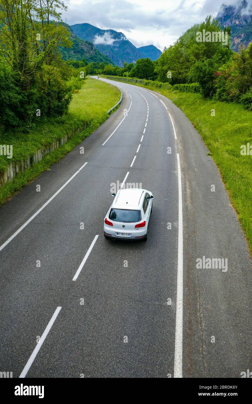 Single white vehicle on quiet road in France during Covid 19 lockdown, May 2020 Stock Photo