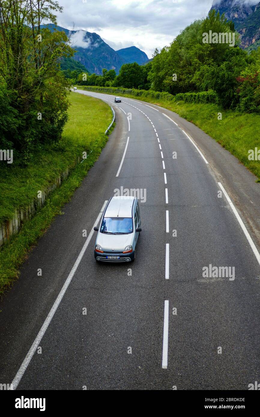 Single white vehicle on quiet road in France during Covid 19 lockdown, May 2020 Stock Photo