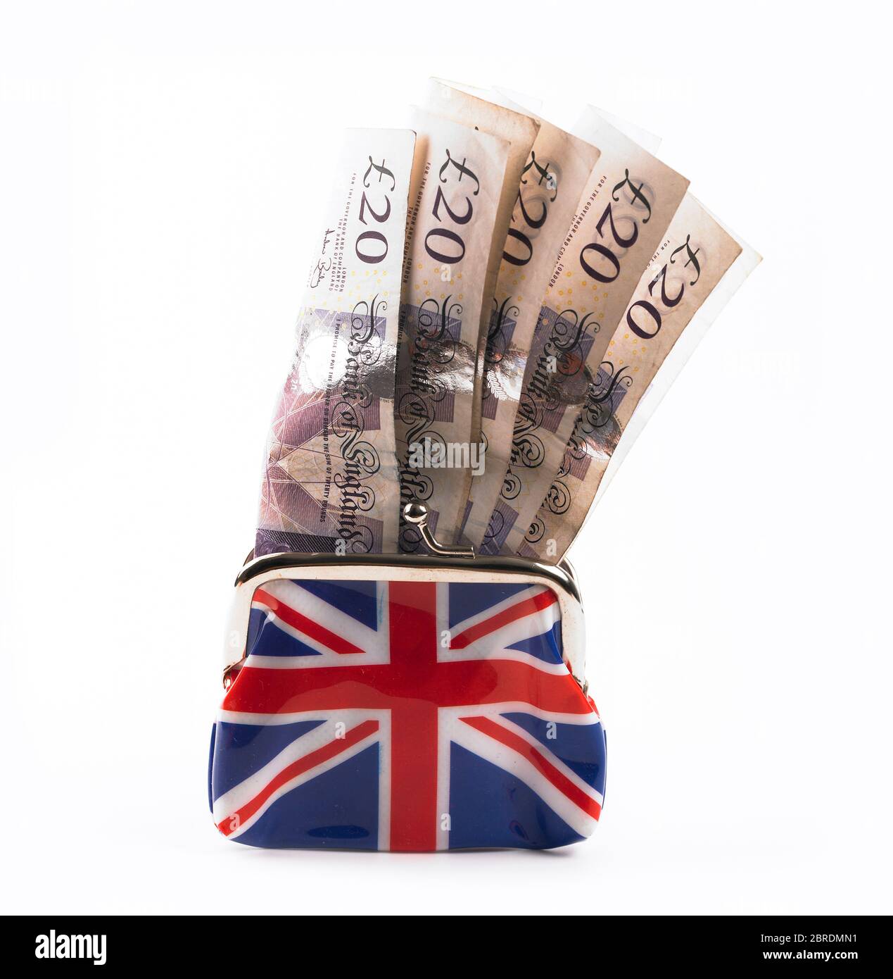 £20 notes stuffed into Union Jack clasp purse on a white background Stock Photo