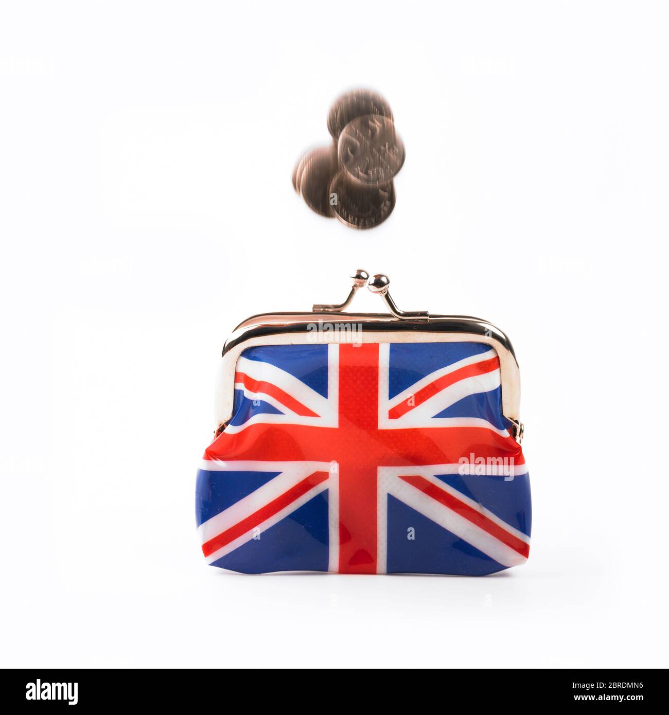 Loose change falling into Union Jack clasp purse on white background Stock Photo