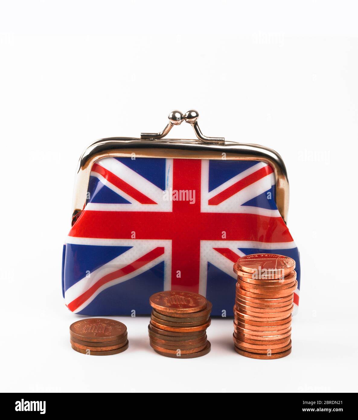 Pennies stacked in front of Union Jack purse Stock Photo