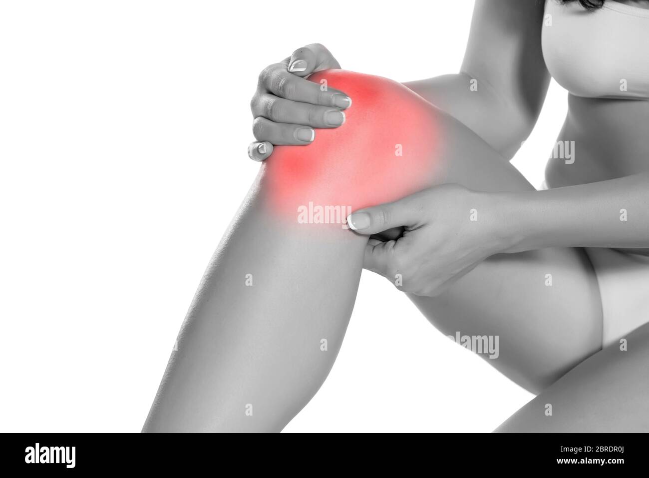 woman holding her painful knee on white background Stock Photo