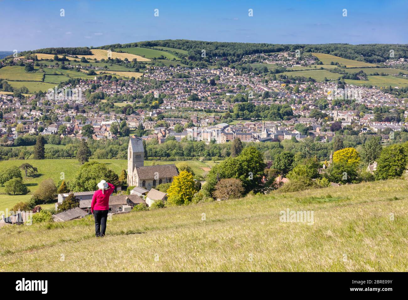 Woman admiring view across to Stroud from Selsley Common, The Cotswolds, Gloucestershire,England, United Kingdom Stock Photo