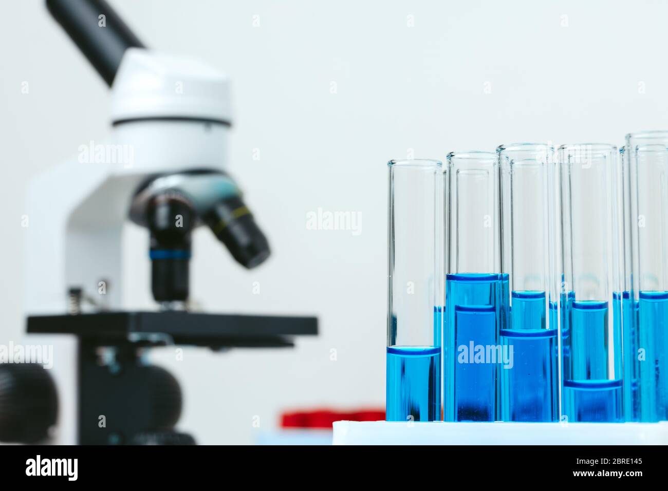 Microscope and test tubes on table in laboratory, close up Stock Photo ...