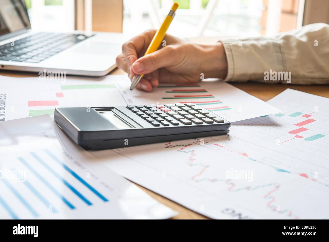 Young business busy working, entrepreneur analyzing financial information as graphics Stock Photo